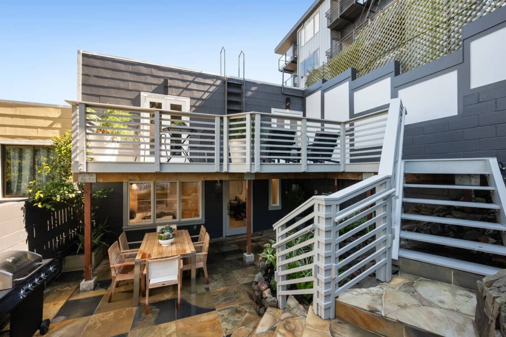 Outdoor living area, stairs, deck and flagstone patio of a home in Noe Valley sold by Danielle Lazier Vivre Real Estate Agents San Francisco.