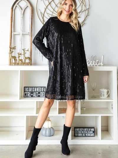 Woman with Wavy Blonde Hair Wearing a Black Sequined Long-Sleeved Party Dress and Black Boots from Ambiance San Francisco