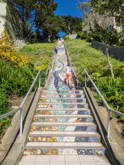 Woman Exercising and Walking up the Colorful Mosaic-Tiled 16th Avenue Tiled Steps in San Francisco