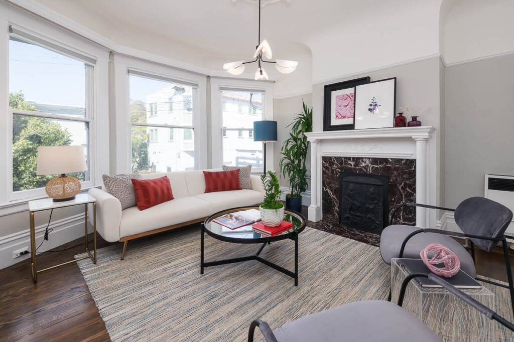 Living room with marble fireplace and bay window from selling home in San Francisco by top Realtor listing agent Danielle Lazier