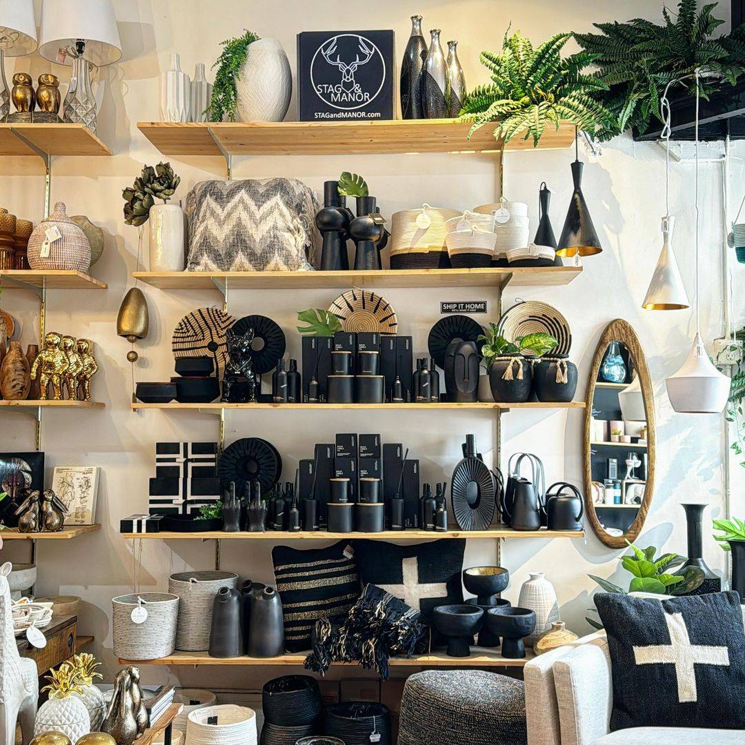 Selection of Artisan Home goods displayed at Stag & Manor including throw pillows and blankets, vases, mirrors, pendant lighting, bowls, and candles