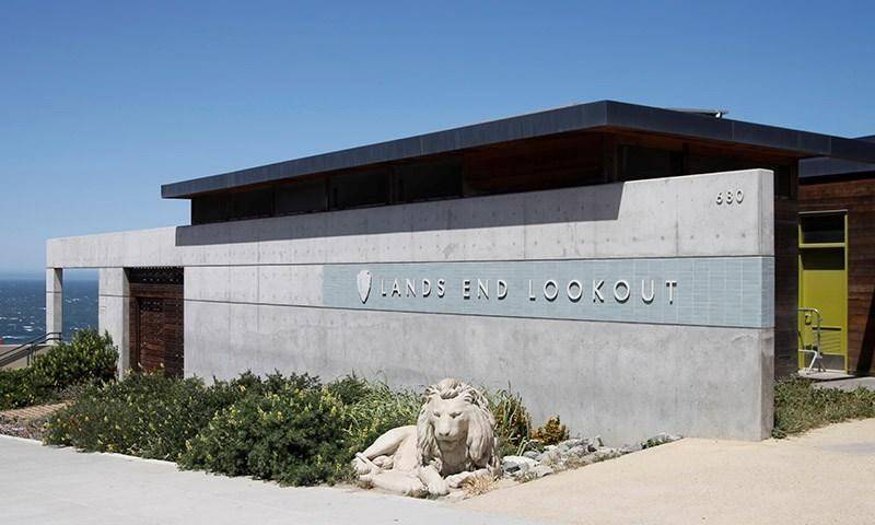 Exterior View of Concrete and Wood Mid century modern building with large block lettering that says “Lands End Lookout”