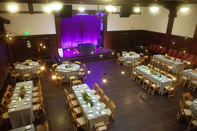 Overhead view of large hall set up with tables with modern tablecloths and place settings for a wedding at Swedish American Hall
