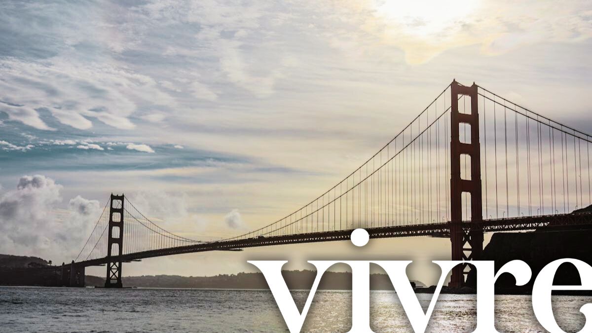 sf real estate is warming up in summer July 2024, top san francisco realtors photo of the bridge with Vivre Real Estate logo overlaid