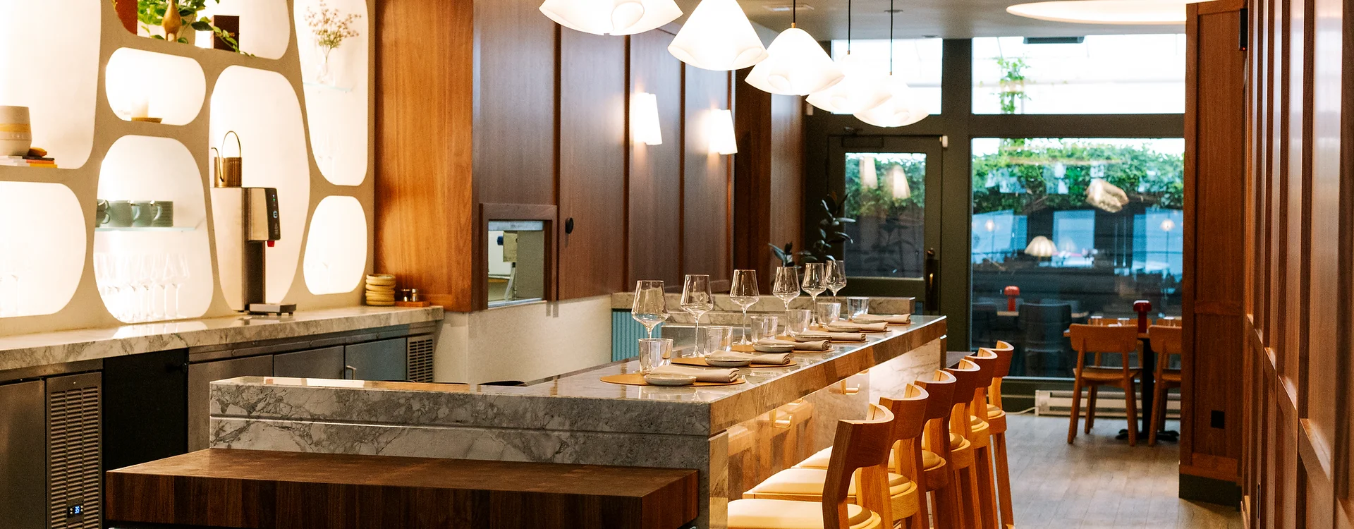 View of Well Lit Interior and Chef’s Counter at the contemporary and upscale 7 Adams, a Michelin starred restaurant in San Francisco.