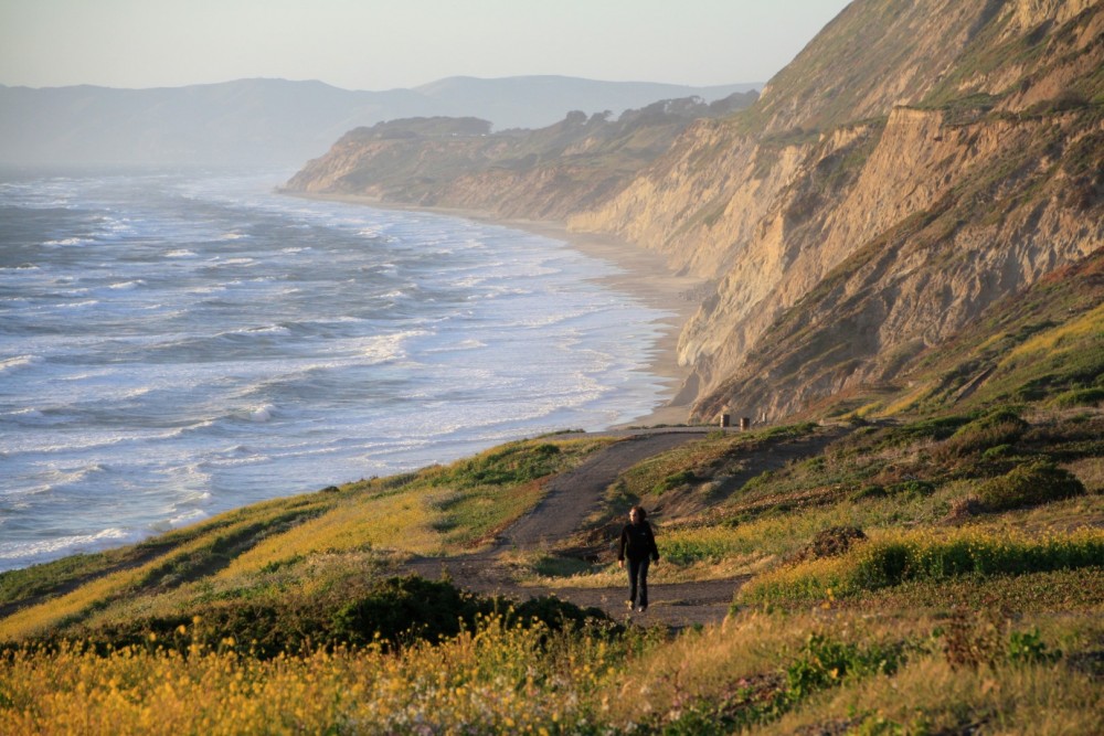 Hilltop view of Pacific Ocean coastline, cliffs, and walking trails at Mussel Rock Park Beach