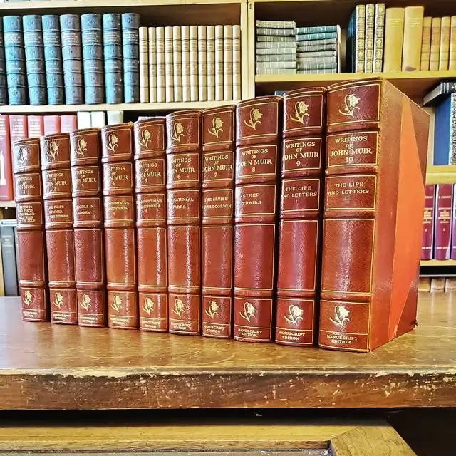 10-volume manuscript set of “The Writings of John Muir”, with other vintage and antique books in the background, offered for sale at Argonaut Book Shop in Nob Hill