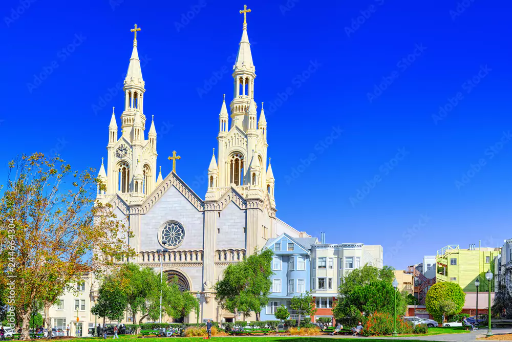 Exterior View of Saints Peter and Paul Church with the two iconic twin steeples topped by crosses on a bright blue day in San Francisco