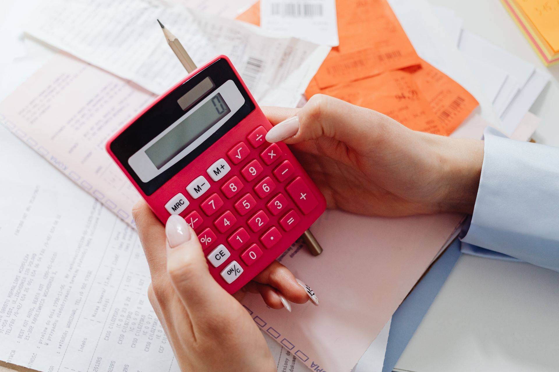 person holding calculator for how does tenant occupancy impact a home sale price in San Francisco real estate by top realtor listing agents danielle lazier vivre real estate